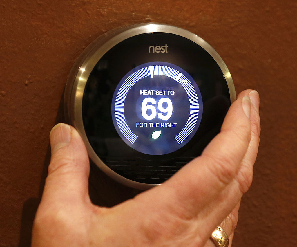 PROVO, UT - JANUARY 16: In this photo illustration, a Nest thermostat is being adjusted in a home o...