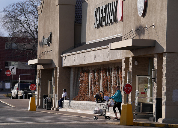 A customer exits a Safeway Inc. store in Denver, Colorado, U.S., on Thursday, Feb. 13, 2014. Safewa...