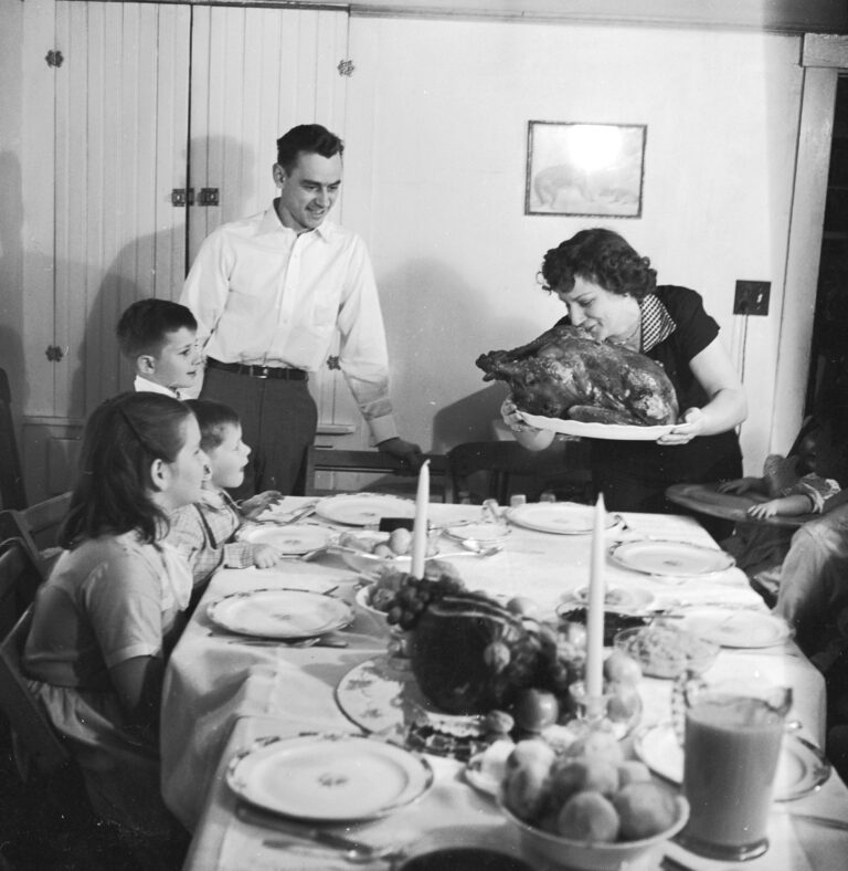 circa 1955:  A Thanksgiving turkey comes to the table watched by the family.  (Photo by Evans/Three...