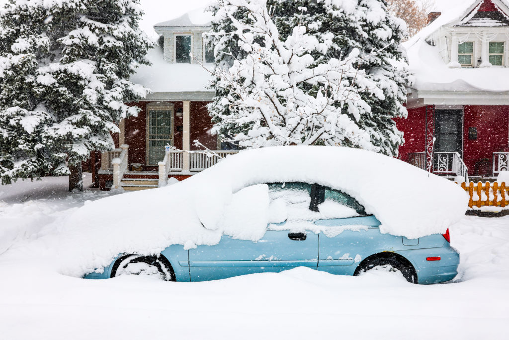 DENVER, CO - MARCH 14: A car sits buried under snow on March 14, 2021 in Denver, Colorado. More tha...