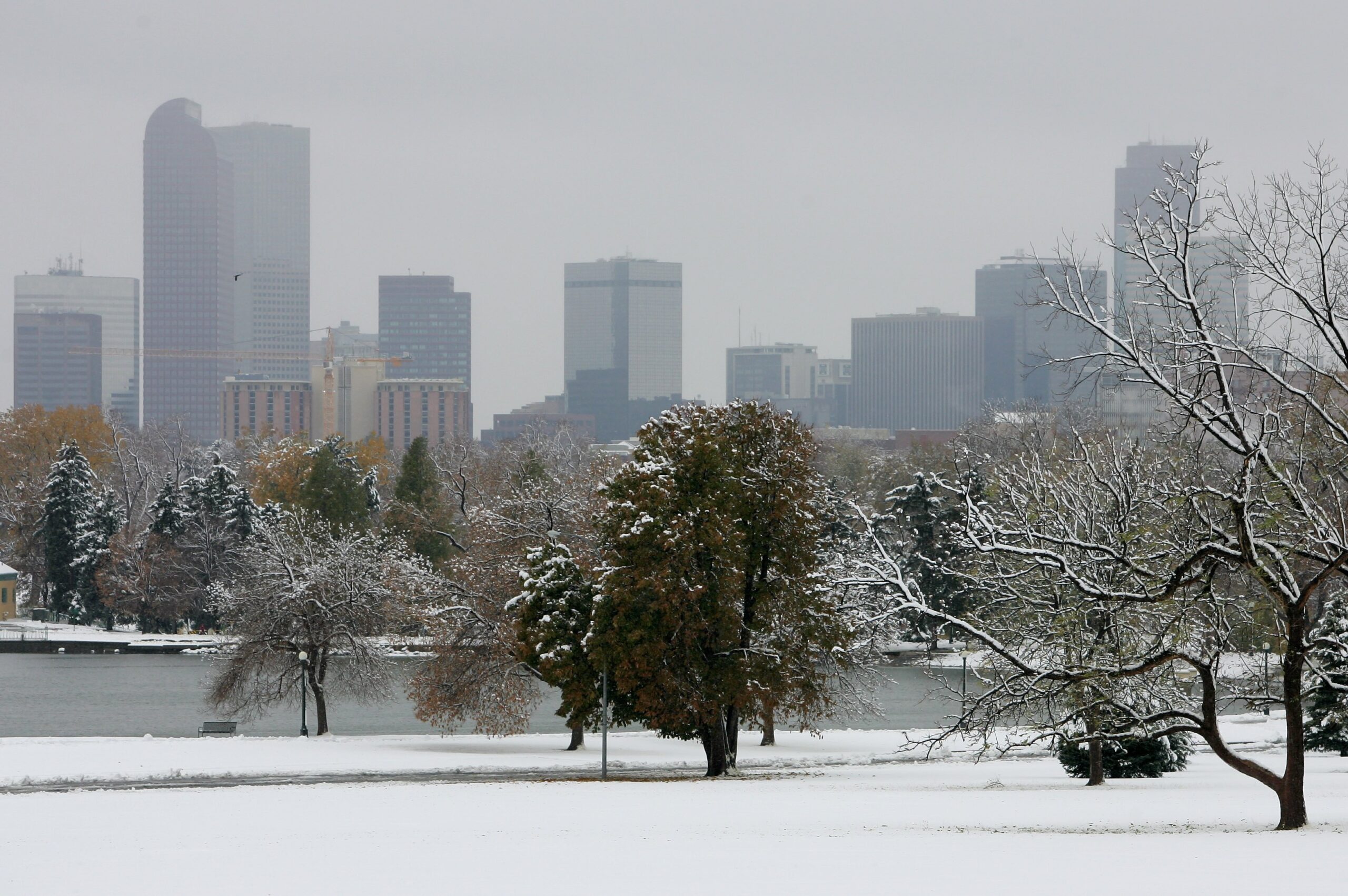 DENVER - OCTOBER 26:  The Denver skyline emerges behind a snow blanketed Denver City Park after an ...