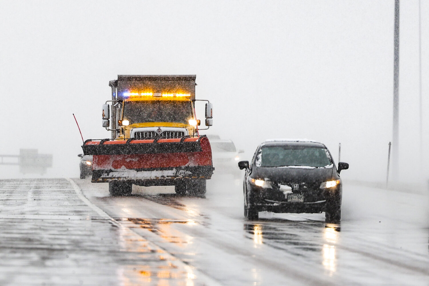 DENVER, CO - MARCH 13: A snow plow drops salt on the road near Denver International Airport on Marc...
