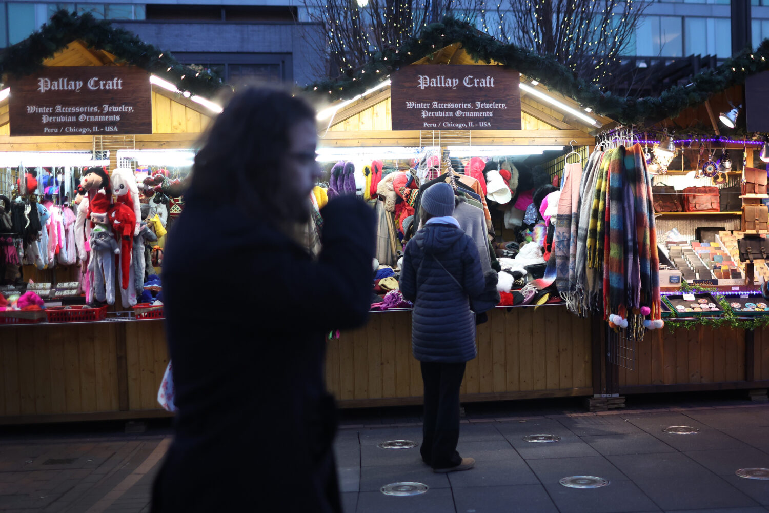 CHICAGO, ILLINOIS - DECEMBER 12: People shop for holiday items at the Christkindlmarket outside of ...