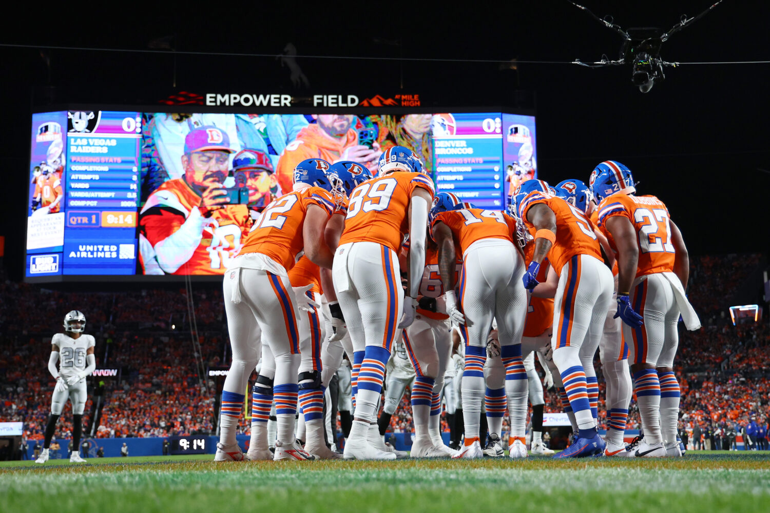 DENVER, COLORADO - NOVEMBER 06: Courtland Sutton #14 of the Denver Broncos huddles with teammates a...