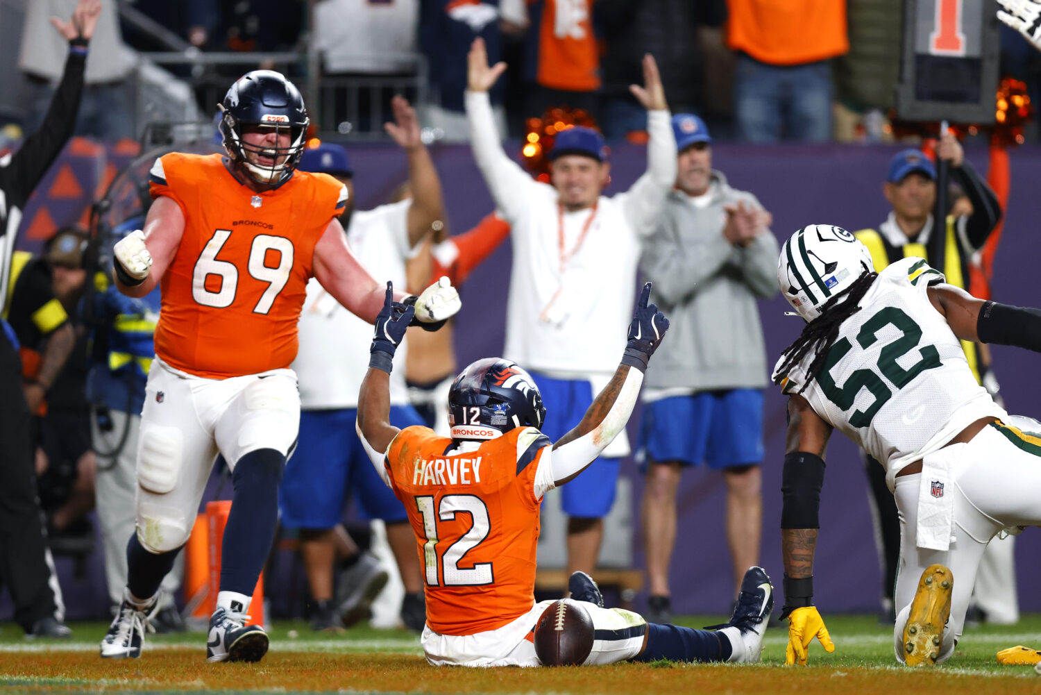 DENVER, COLORADO - DECEMBER 14: RJ Harvey #12 of the Denver Broncos celebrates after scoring a rush...