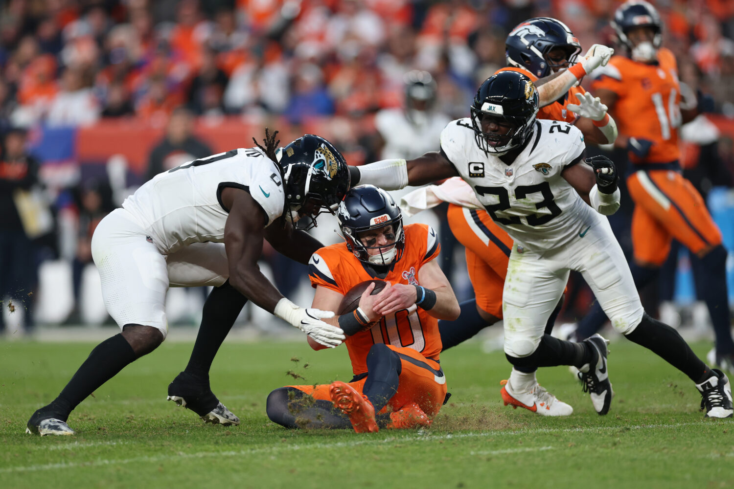 DENVER, COLORADO - DECEMBER 21: s #10 of the Denver Broncos is tackled during the second half again...