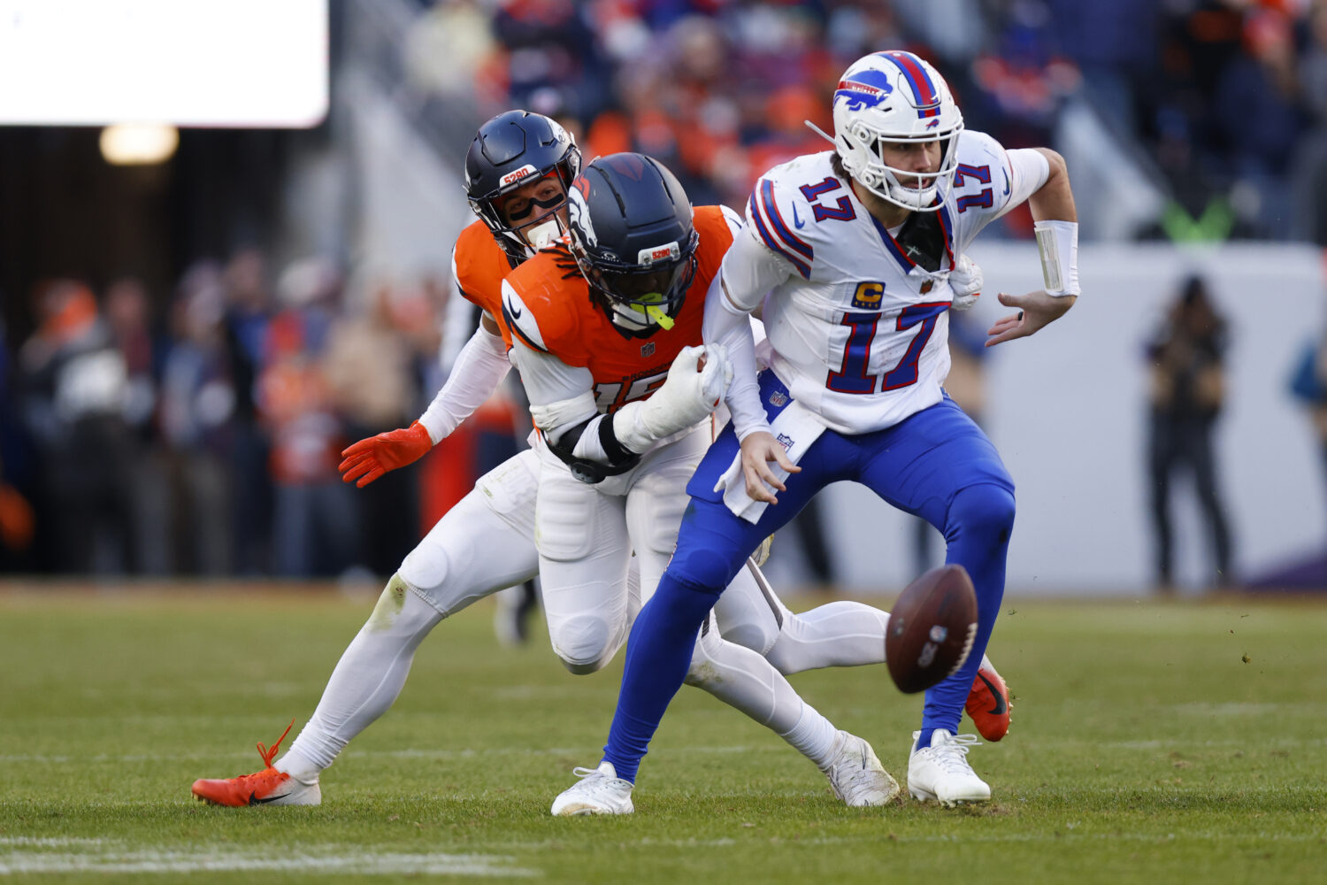 DENVER, COLORADO - JANUARY 17: Josh Allen #17 of the Buffalo Bills fumbles the ball against the Den...