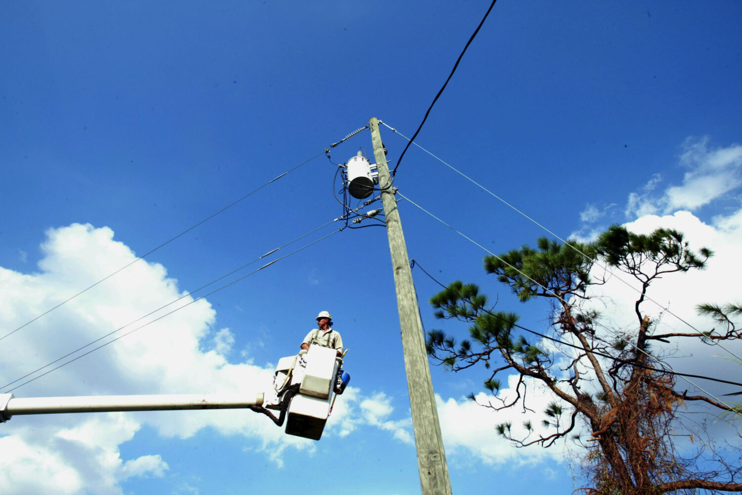 SEBASTIAN, FL - SEPTEMBER 28:  Mike Baker, a lineman for XCel Energy from Texas, works on restoring...