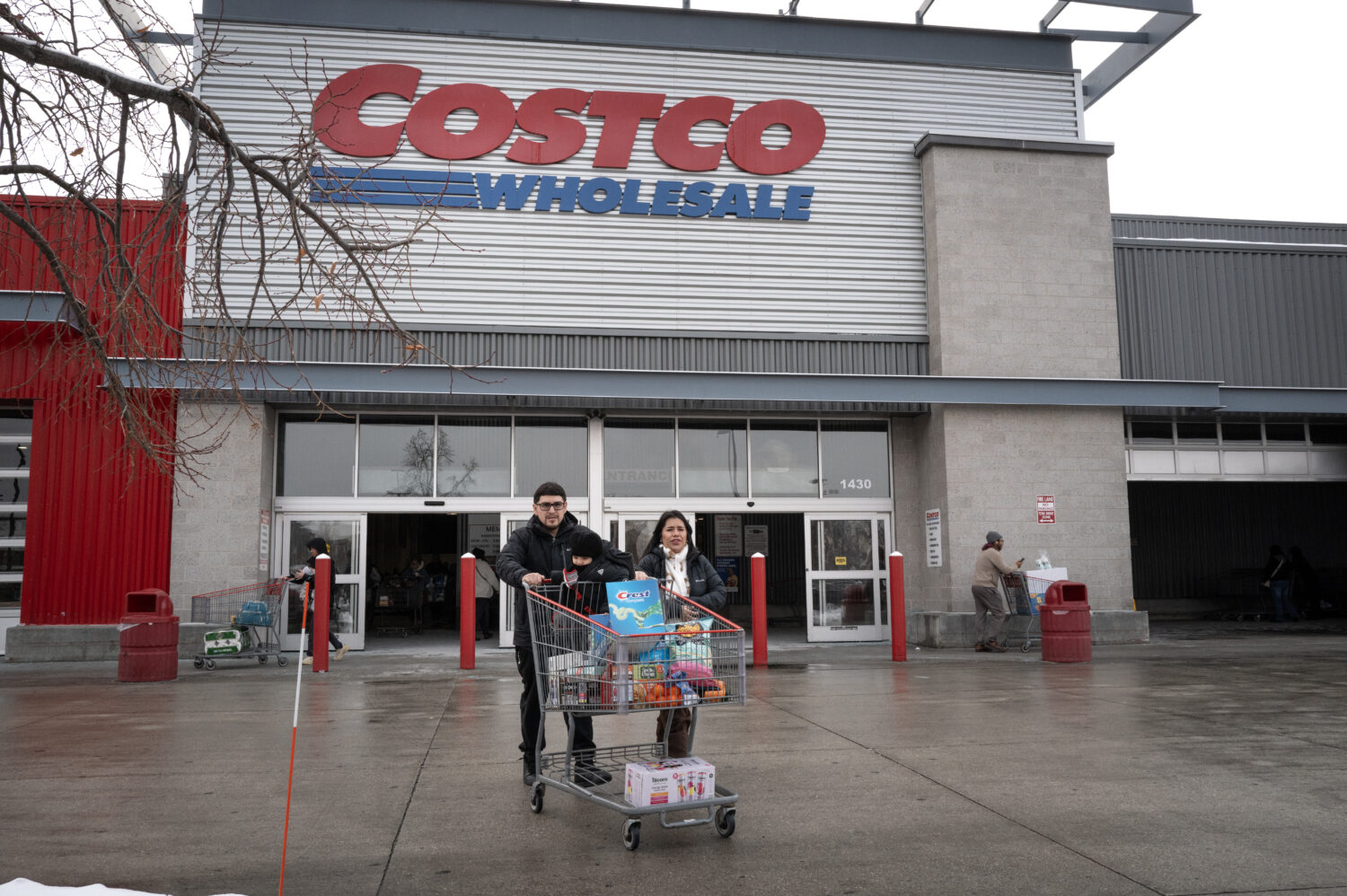 CHICAGO, ILLINOIS - DECEMBER 02: Customers walk in the parking lot outside a Costco store on Decemb...
