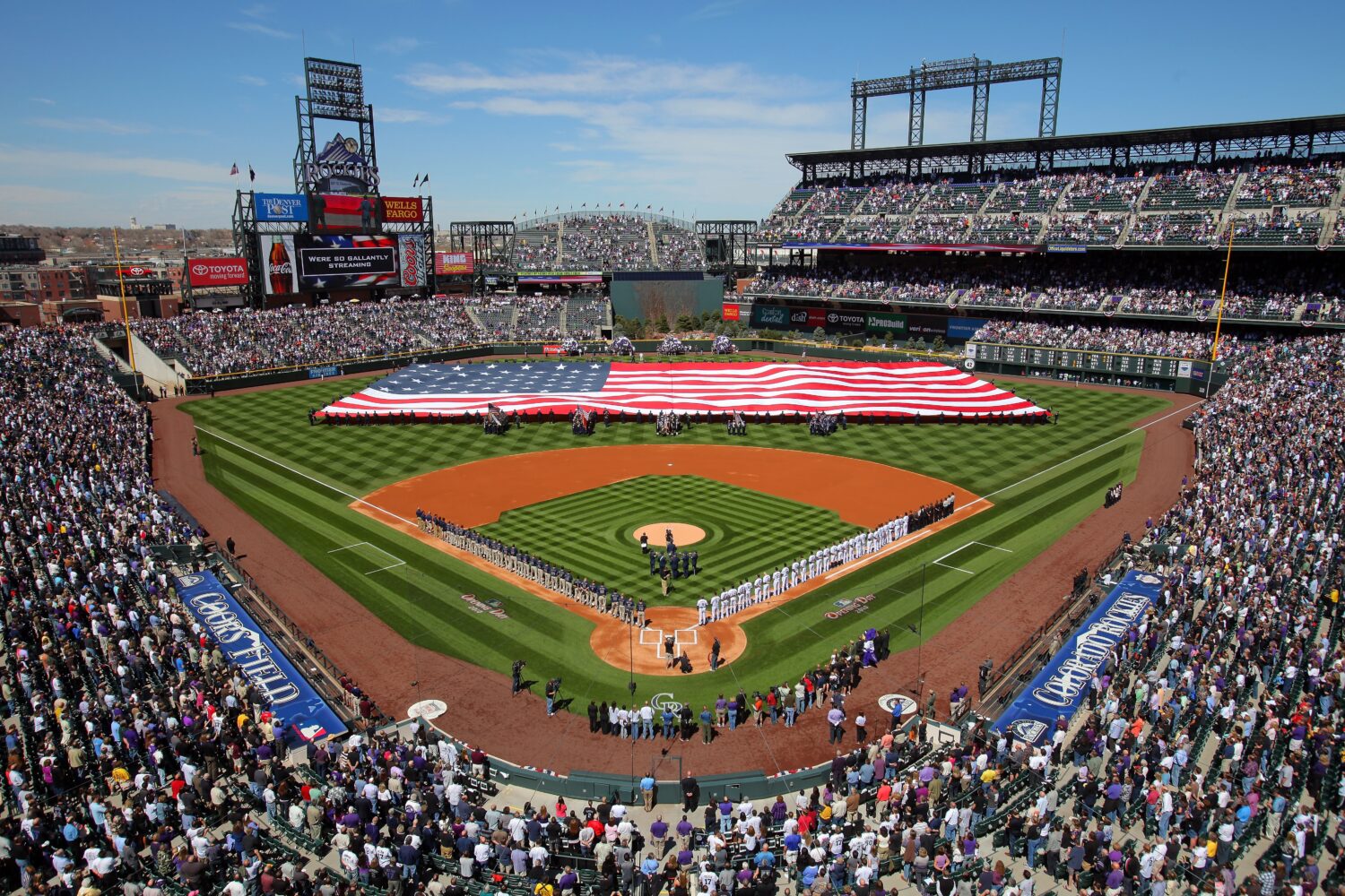 DENVER - APRIL 09:  Players and fans observe the national anthem as the stars and stripes is presen...
