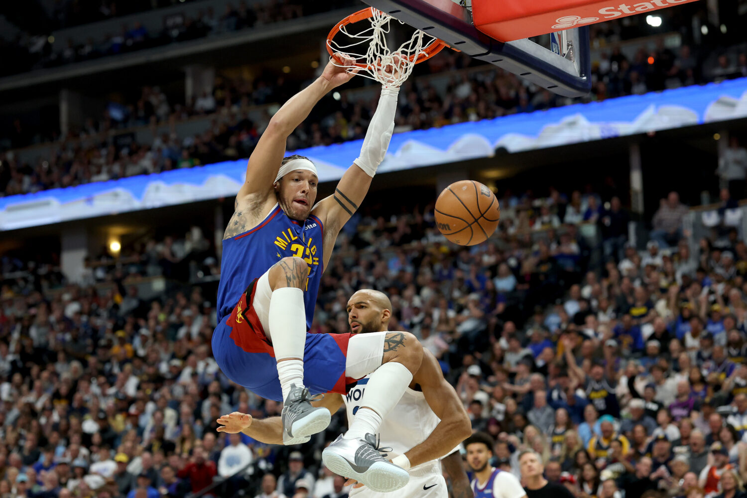 DENVER, COLORADO - APRIL 20: Aaron Gordon #32 of the Denver Nuggets dunks on Rudy Gobert #27 of the...