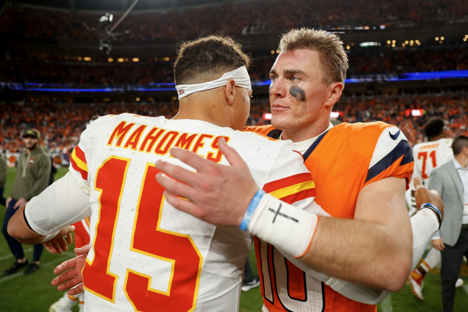 DENVER, COLORADO - NOVEMBER 16: Patrick Mahomes #15 of the Kansas City Chiefs hugs Bo Nix #10 of th...