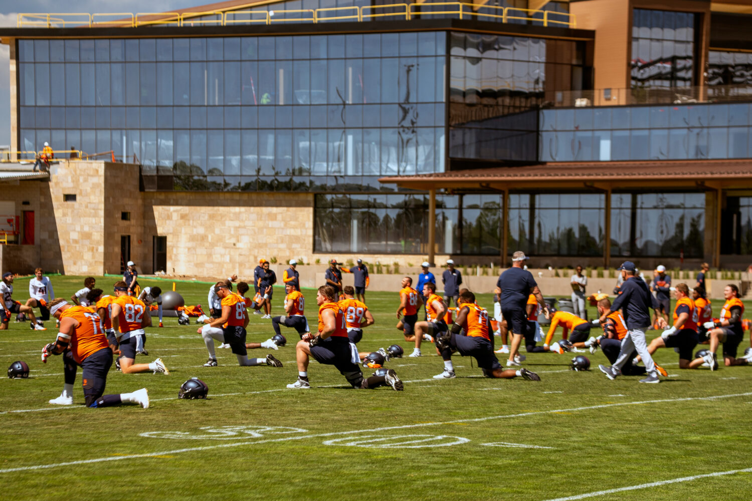 ENGLEWOOD, COLORADO - JUNE 4: Members of the Denver Broncos stretch prior to organized team activit...