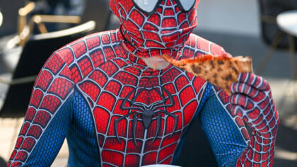NEW YORK, NEW YORK - OCTOBER 06: A Spider-Man cosplayer poses with pizza during New York Comic Con ...
