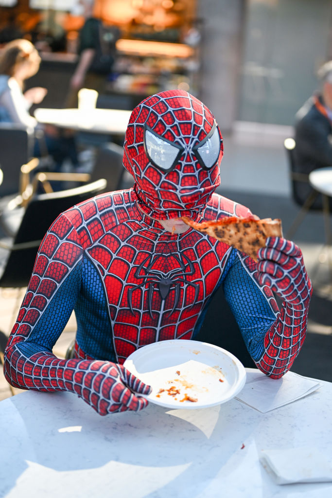 NEW YORK, NEW YORK - OCTOBER 06: A Spider-Man cosplayer poses with pizza during New York Comic Con ...