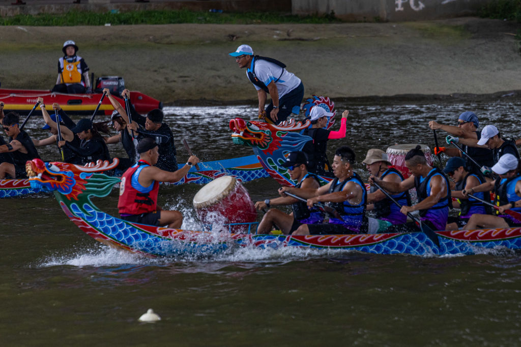 TAIPEI, TAIWAN - JUNE 22: The participants of the Dragon Boat competition race during the Dragon Bo...