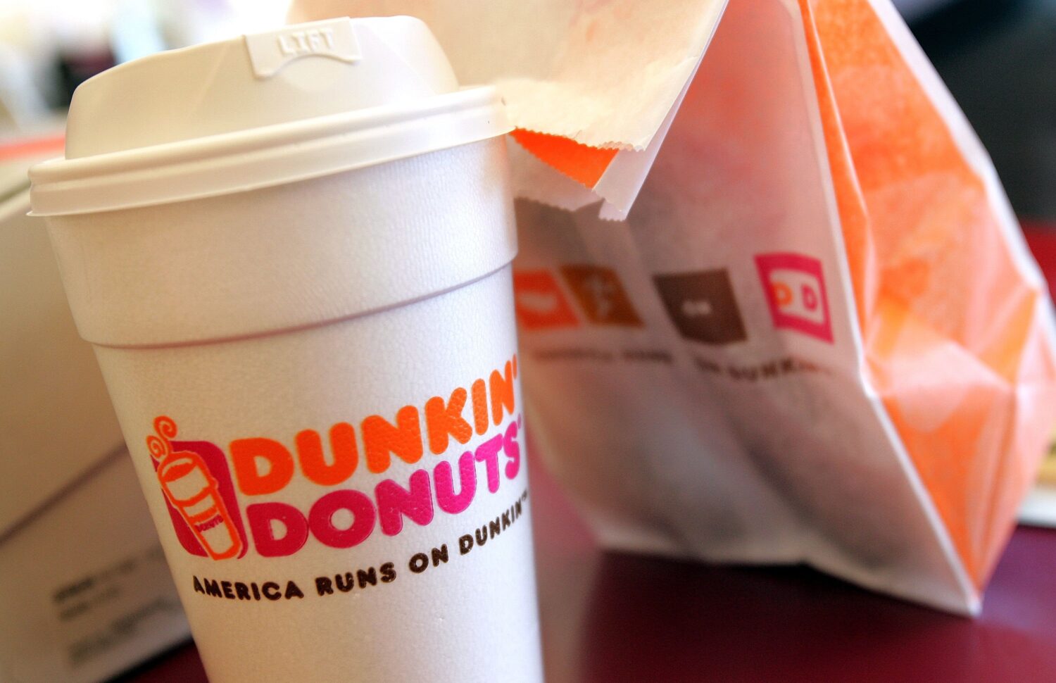 CHICAGO - SEPTEMBER 07:   A cup of Dunkin' Donuts coffee and a donut bag sit on a counter September...