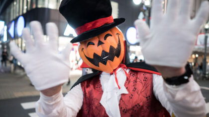 TOKYO, JAPAN - OCTOBER 31: A man wearing a costume waves near Shibuya Crossing during Halloween on ...