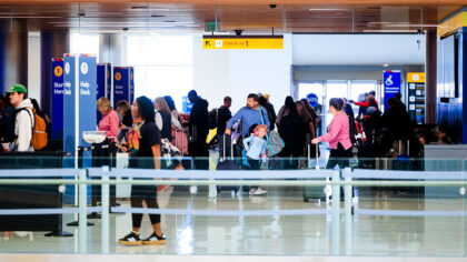 DENVER, COLORADO - NOVEMBER 8: People walk through Denver International Airport on November 8, 2025...