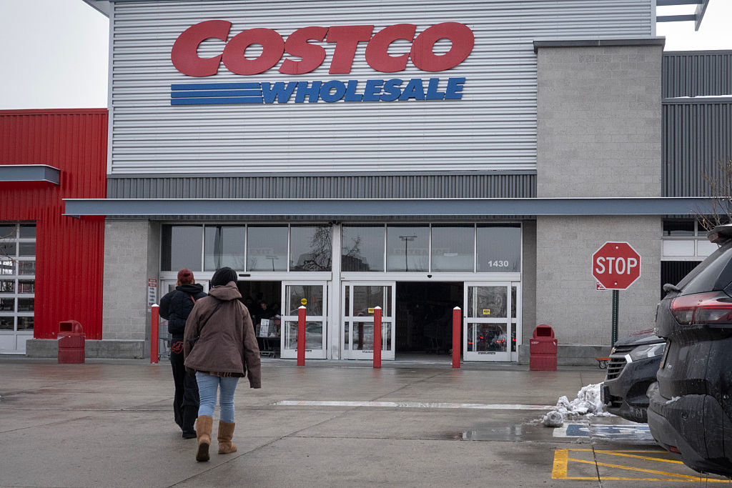 CHICAGO, ILLINOIS - DECEMBER 02: Customers walk in the parking lot outside a Costco store on Decemb...