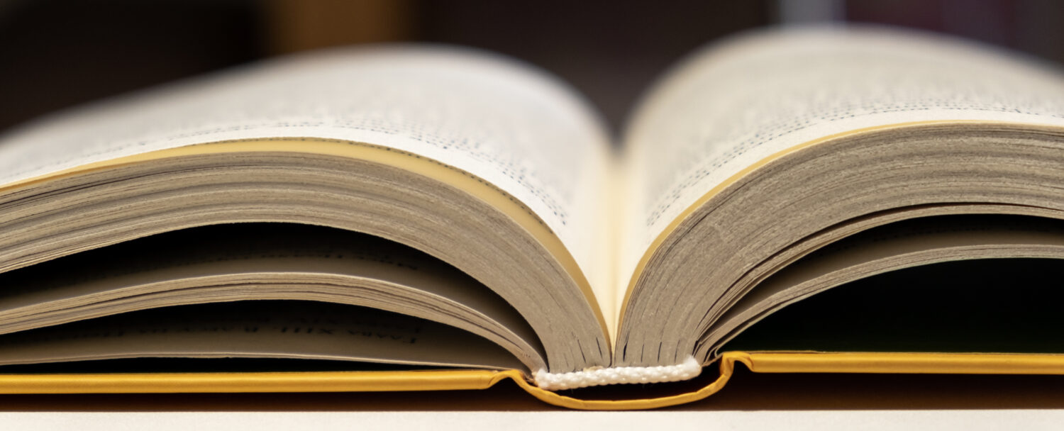 Open book close up. One book is yellow. Concept of reading and learning books....
